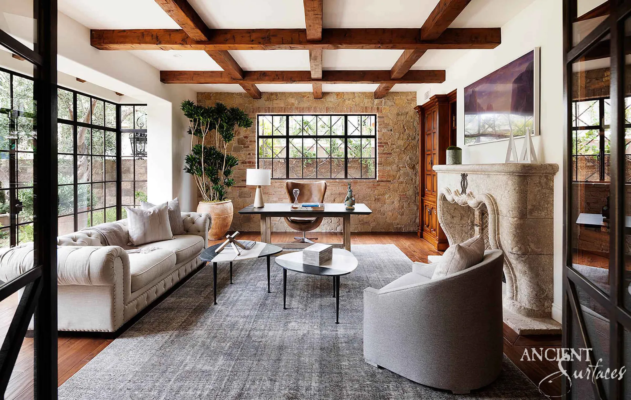 Antique reclaimed limestone fireplace mantel presented as an architectural feature in a bright room